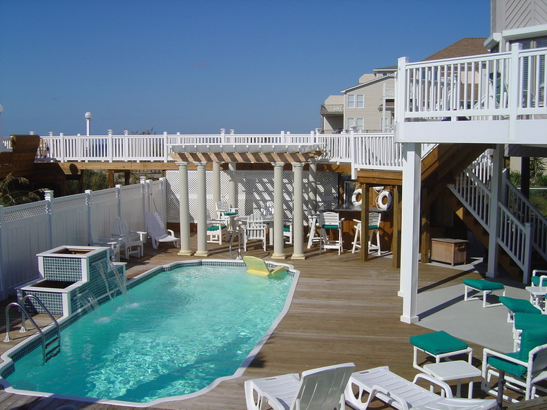 Pergola with fiberglass columns, vinyl railing and privacy fence with lattice, solar and low voltage lights