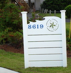 Driveway entrance fence with sanddollar CNC design